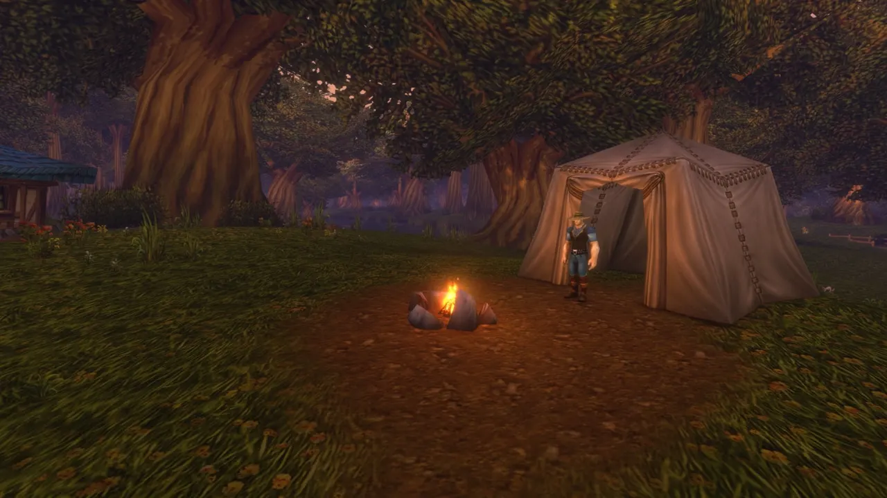 A campfire beside a canvas tent in a forest clearing