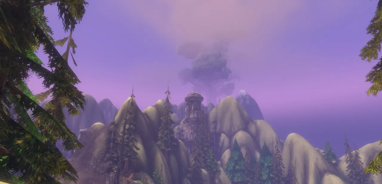 Forested mountain slopes under a purple sky