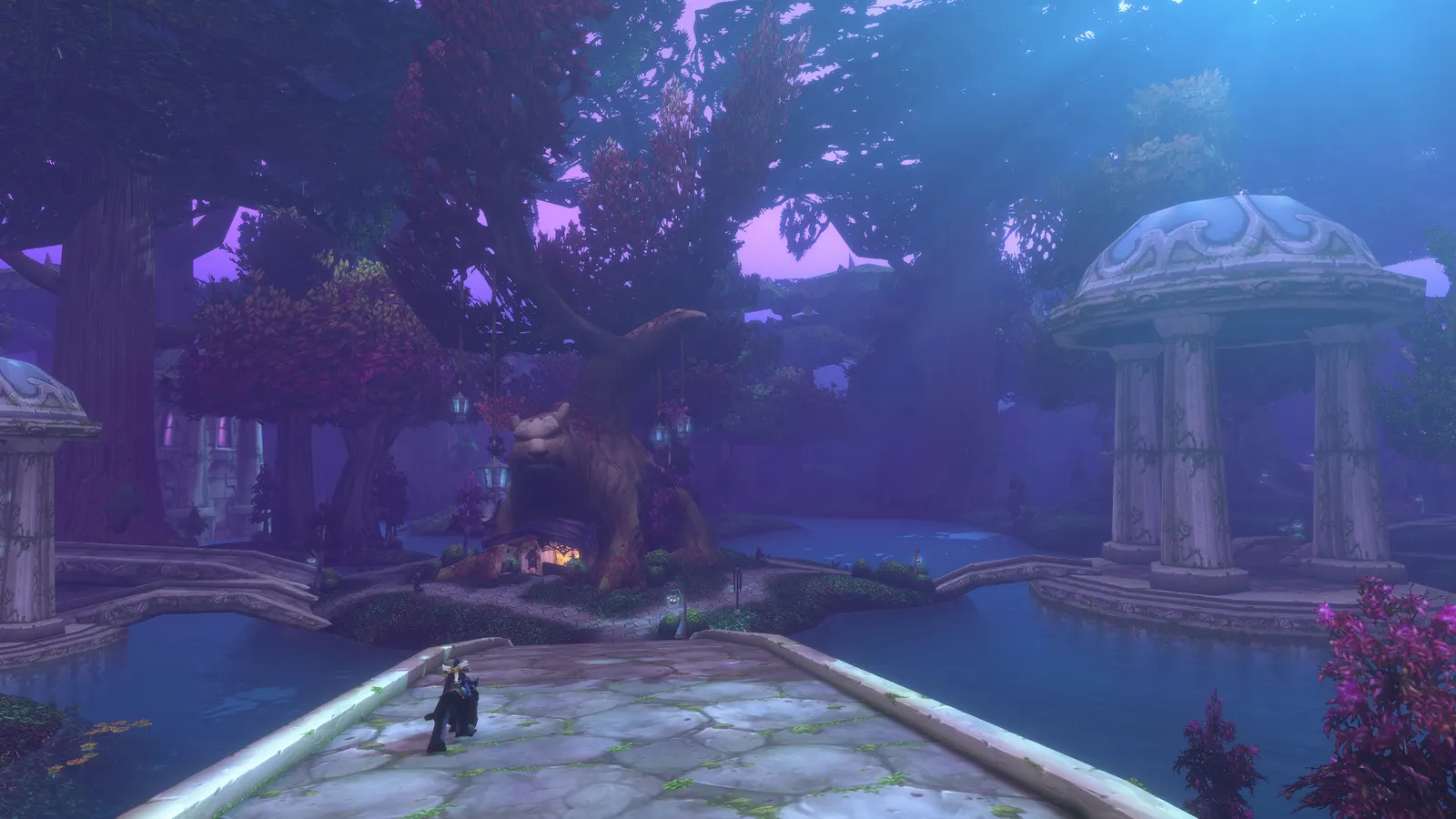 A moonlit plaza with a great tree and domed pavilions