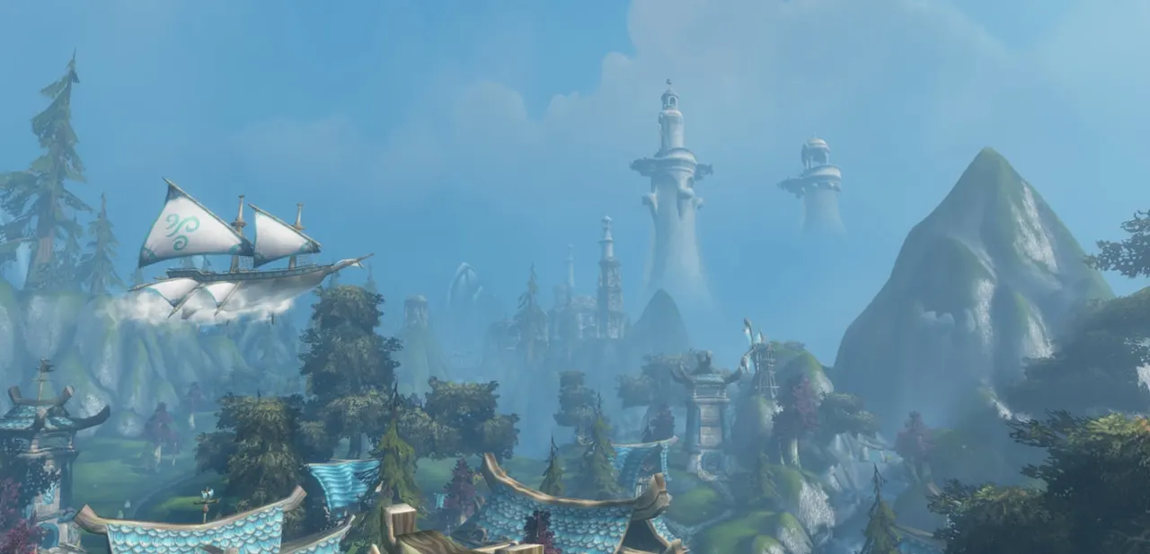 An airship over a valley of towers and peaks
